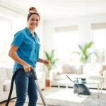 Efficient residential cleaning Georgia in a sunlit home, highlighting a joyful cleaner.